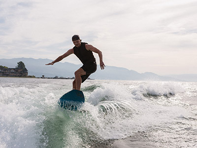 A wakesurfer riding on Okanagan Lake